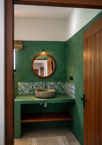 a bathroom with a sink and a mirror at Drop Inn Studios in Ahangama