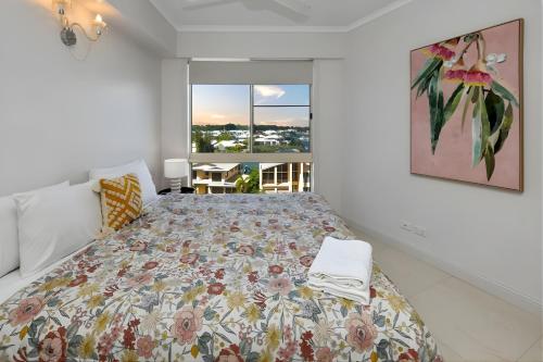 a bedroom with a bed and a large window at Sunset Stunner Marina Views in Larrakeyah