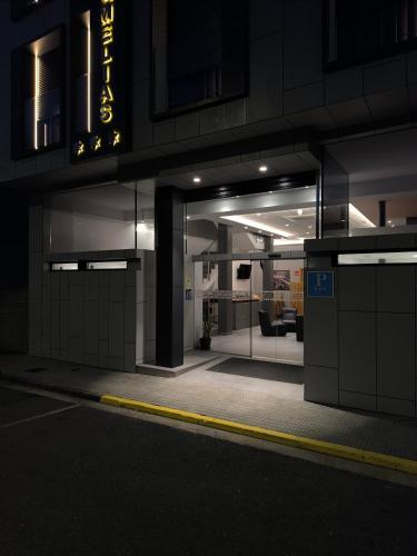 a nighttime view of a building at night at Praza Camelias in Sarria