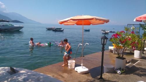 a group of people swimming in the water at 'By the Lake' Apartments in Ohrid