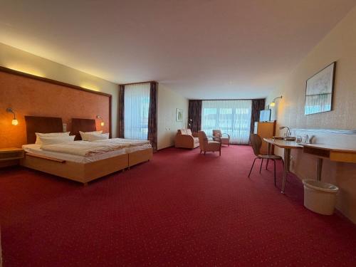 a large hotel room with a bed and a bathroom at Hotel Ascot Bristol in Potsdam