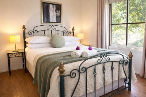 a bedroom with a bed with two stuffed animals on it at Balingup Highview Chalets in Balingup