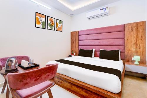 a bedroom with a bed and a desk with a chair at Townhouse Govardhan in Govardhan