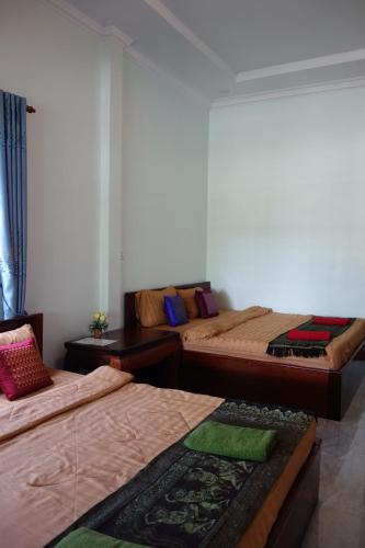 a room with three beds in a room at AHHA Bungalow Kampot in Kampot