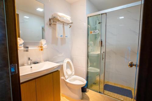 a bathroom with a toilet and a sink and a shower at Best Hotel in Johor Bahru