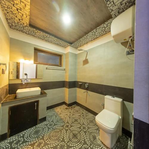 a bathroom with a toilet and a sink at Hotel La Park, Leh in Leh
