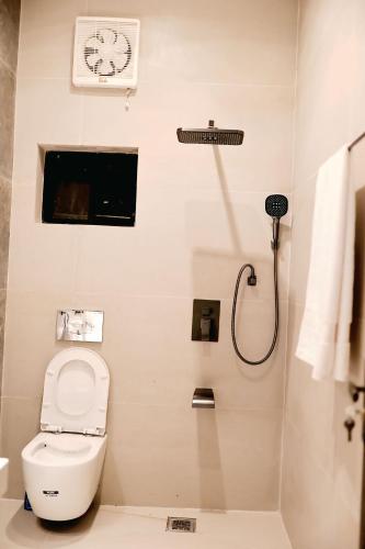 a bathroom with a toilet and a shower at The Grandeur Suite 1 in Rawalpindi