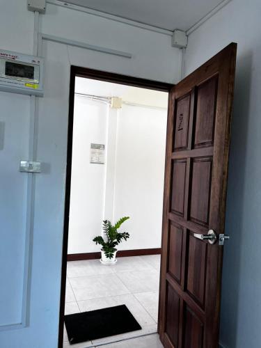 a door leading into a room with a potted plant at Ko Lipe Appartamenti in Ko Lipe
