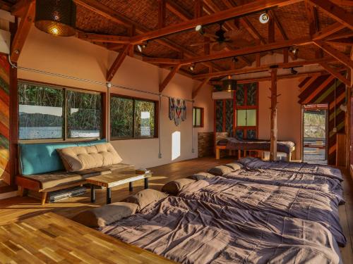 a bedroom with a large bed and a couch at 2four Villa Costa in Minamiise