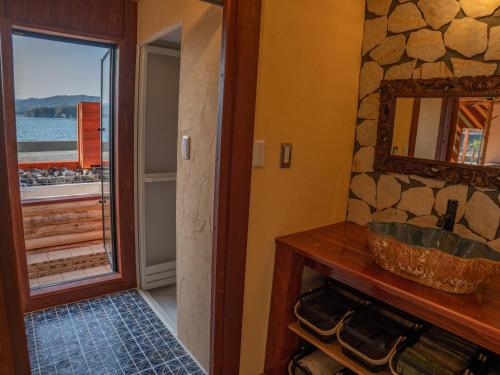 a bathroom with a sink and a mirror and a window at 2four Villa Costa in Minamiise