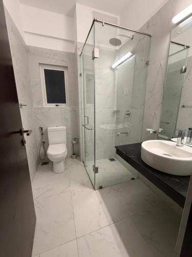 a bathroom with a toilet and a sink and a shower at Colombo lotus tower view Apartment in Colombo