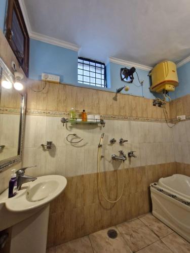a bathroom with a shower and a sink and a toilet at The Nomad cave in Lucknow