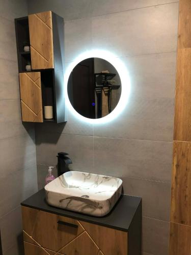a bathroom with a sink and a mirror at Guest House ELIYA in Devin