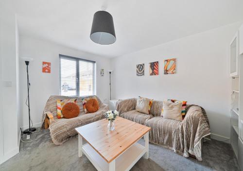 a living room with a couch and a table at The Nest Retreat Exeter in Exeter