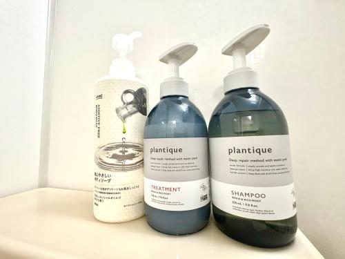 three bottles of cleaning products sitting on a shelf at FUJI Forest House103 in Gotemba