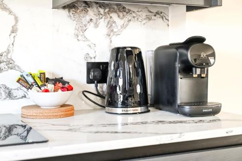 a coffeemaker sitting on a counter next to a coffee maker at Luxury Apartments in Marylebone Village in London