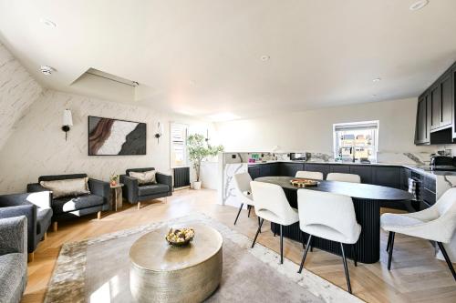 a living room with a table and some chairs at Luxury Apartments in Marylebone Village in London