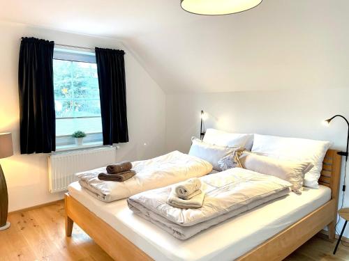 a bedroom with a bed with two towels on it at Appartement Bergtraum - by myNests in Gröbming