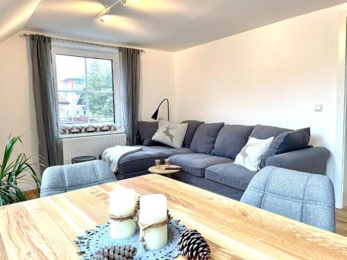 a living room with a blue couch and a table at Appartement Bergtraum - by myNests in Gröbming