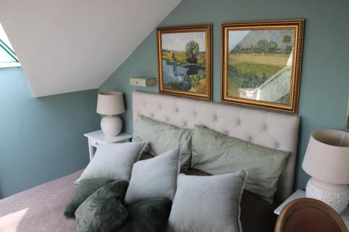 a bedroom with a bed with two pictures on the wall at Hideaway Palais Auersperg in Salzburg