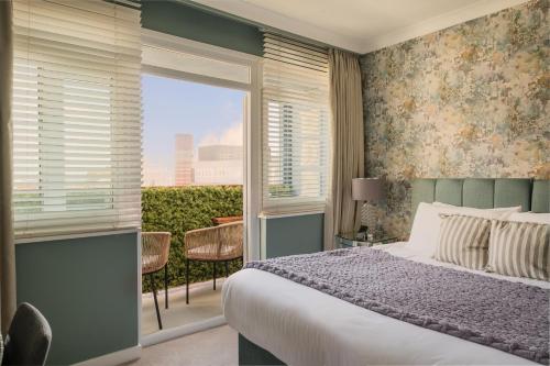 a bedroom with a bed and a large window at Sunset Apartment - 7th Floor Double Tree in Brighton & Hove