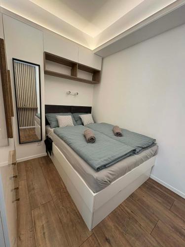 a bedroom with a large bed in a room at H&H Apartman in Fonyód