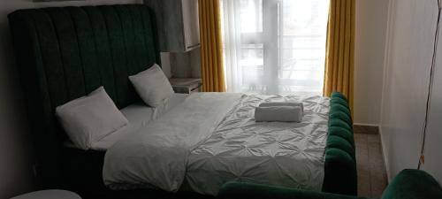 a bedroom with a bed with a laptop on it at Starla, Duplex in Nairobi