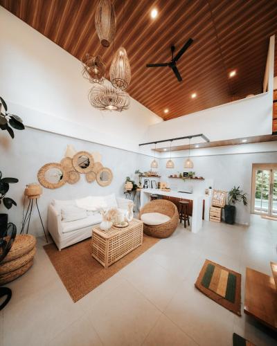 a living room with a couch and a table at Balay nimo by Sachzna in Amadeo