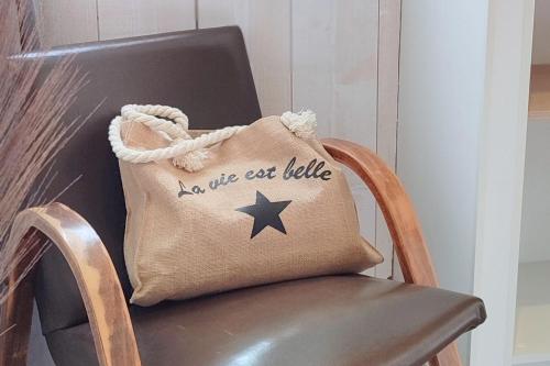 a bag sitting on a chair with a star on it at Gîte de charme Beaujoyeulx in Molineuf