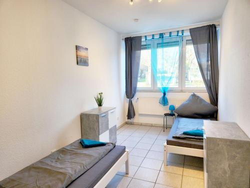a bedroom with two beds and a window at AC01-AC06 Apartment in Herzogenrath in Herzogenrath
