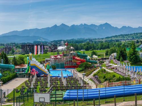 a water park with a pool and slides at Apartamenty Przełom Białki - plac zabaw, wiata grillowa in Białka Tatrzańska