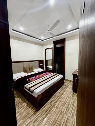 a bedroom with a large bed in a room at Jeevak hotel in Mohali