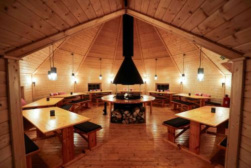 a large room with wooden tables and benches at Hotel und Kongresszentrum Wanderath in Baar