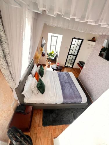 an overhead view of a bed in a bedroom at CLASSIC BNBs MILIMANI in Kisumu