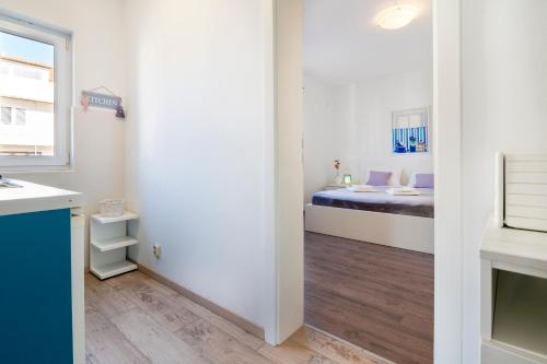 a room with a bedroom with a bed at Guest House Kovacevic in Hvar