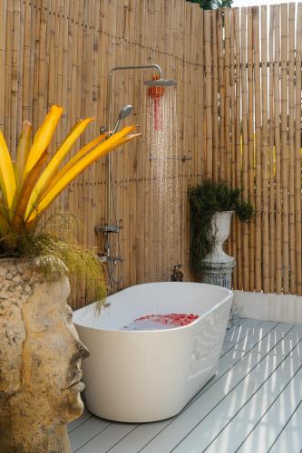 a bath tub sitting on top of a wooden wall at Lime Splash Private pool in Choeng Mon Beach
