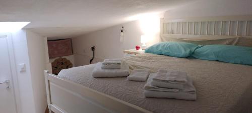 a bedroom with a bed with towels on it at Sardinia Breeze - Costa Serena in Porto Rafael