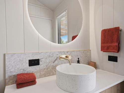 a bathroom with a white sink and a mirror at Maydena Alpine Retreat in Maydena