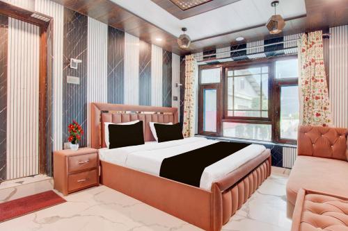 a bedroom with a large bed and a window at Collection O Foreshore Road Srinagar in Srinagar
