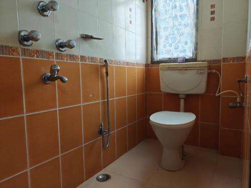 a bathroom with a toilet and a shower at Oasis Hotel and Restaurant in Siliguri
