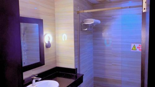 a bathroom with a sink and a glass shower at Brus View Suites in Ilado