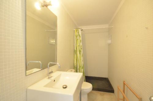 a bathroom with a sink and a toilet and a mirror at Els Llorers - Ref.050 in Begur