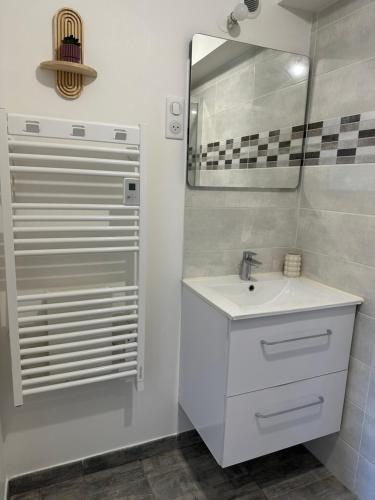 a white bathroom with a sink and a mirror at LAVANDE studio 4 personnes in Château-Arnoux-Saint-Auban