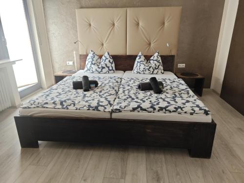 a bedroom with a bed with pillows on it at Hotel am Markt Eschweiler in Eschweiler