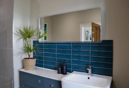 a bathroom with a sink and a mirror at St Michaels Reach Guest House in Marazion