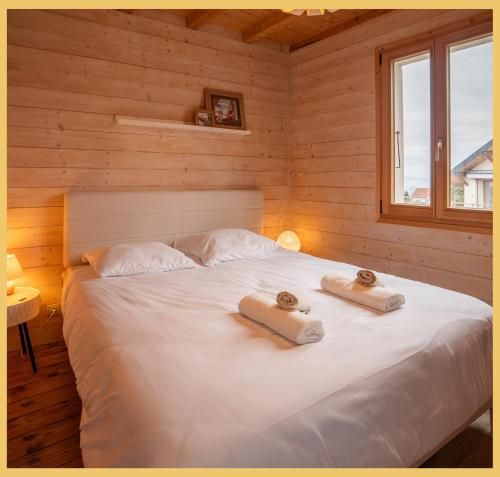 a bedroom with a bed with two towels on it at Maison Méserier I T3 I Publier in Publier