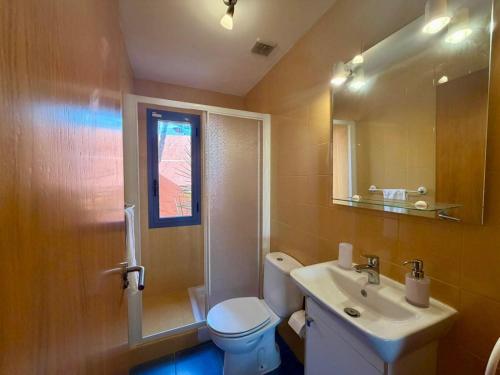 a bathroom with a white toilet and a sink at Montaña Blanca - Casa Bimba in Caleta De Fuste