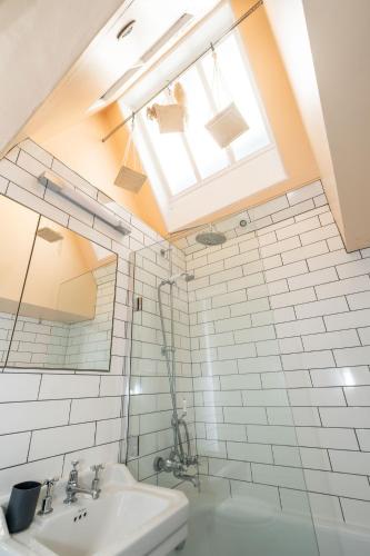 a bathroom with a sink and a window at Hill House Apartment in Framlingham