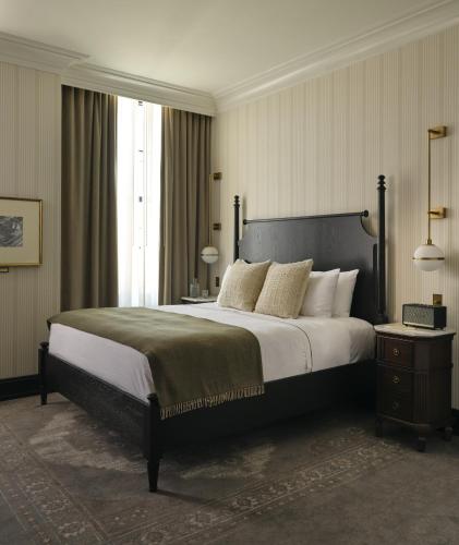 a bedroom with a large bed and a large window at Hotel 1928 in Waco
