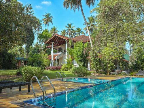 a swimming pool in front of a villa at The Villa Green Inn in Negombo